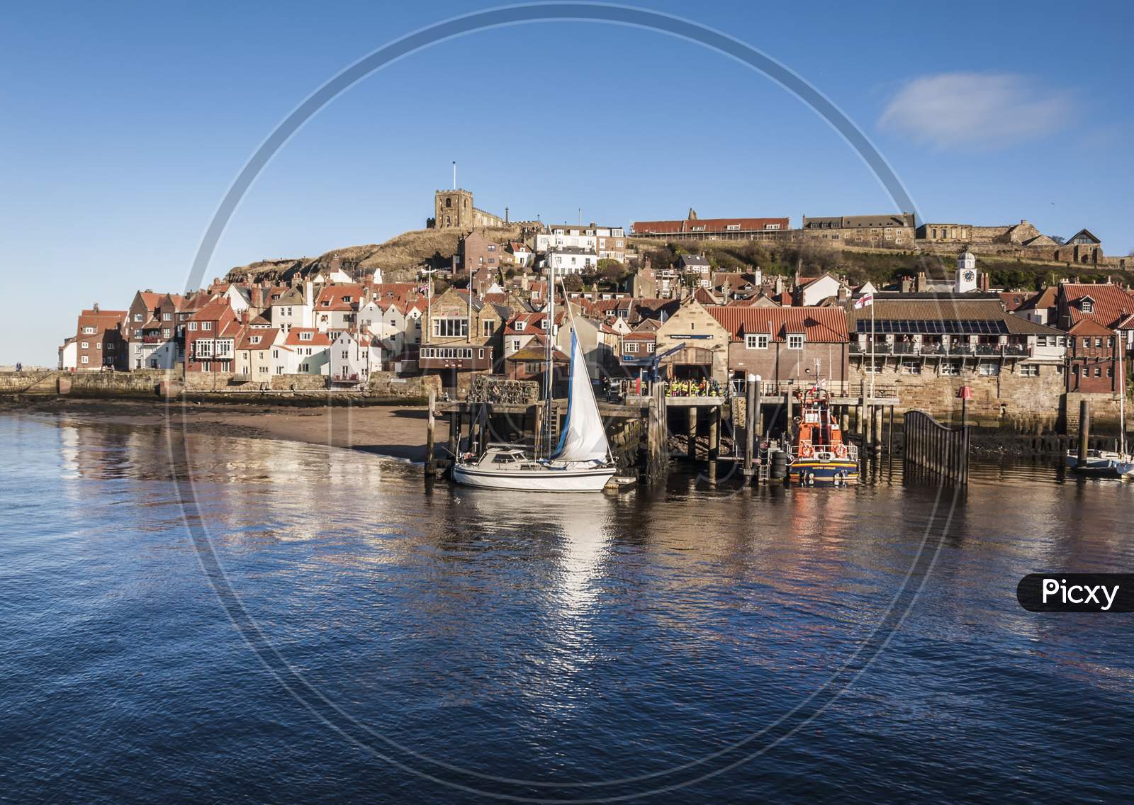 With a boat moored by the side of Whitby’s life boat.