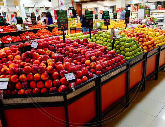 Bunch Of Red, Yellow And Green Apples On Boxes In Supermarket. Apples Being Sold At Public Market. Organic Food Fresh Apples In Shop, Store  - India