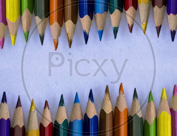 Group Of Colorful Wooden Pencils On Grainy White Background And Space For Text At Middle