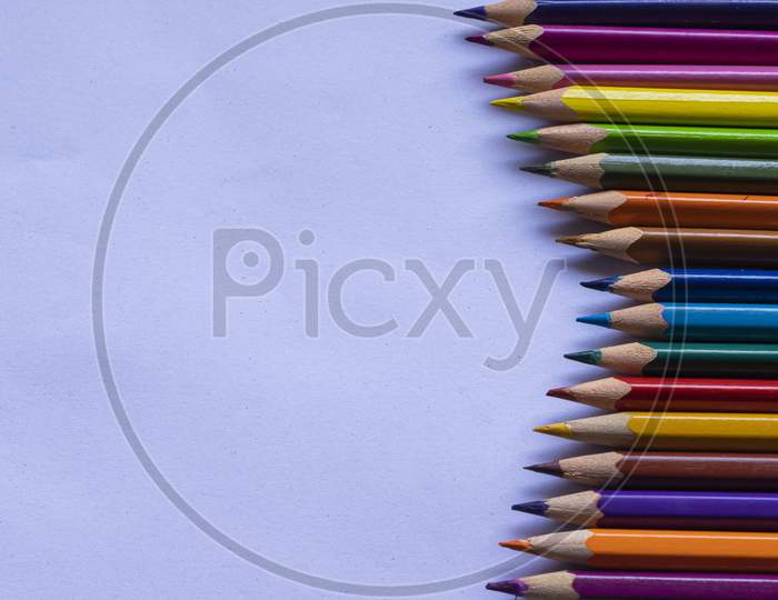 Group Of Colorful Wooden Pencils On Grainy White Background And Space For Text On Left Side