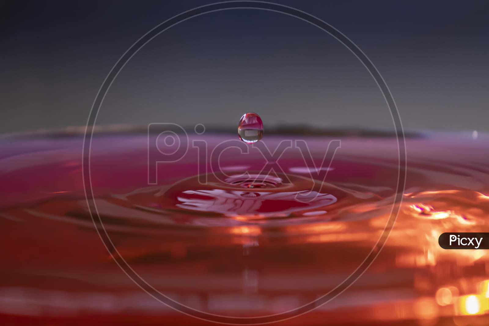 Water Droplet Falling On Water Surface Pink Red Colour