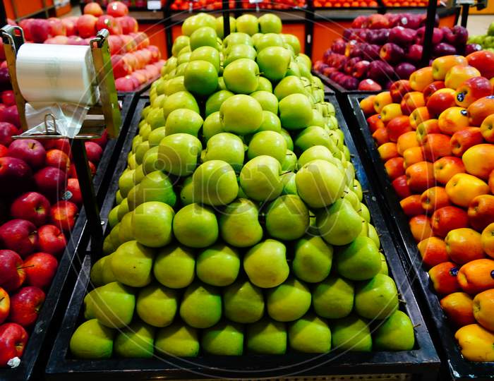 Bunch Of Green, Orange, Red Apples On Boxes In Supermarket. Apples Being Sold At Public Market. Organic Food Fresh Apples In Shop, Store - India