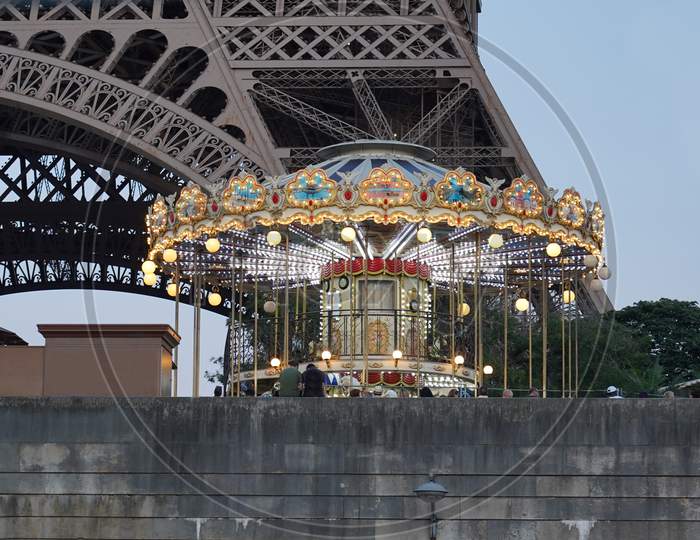 Illuminated carousel in front of the Eiffel Tower after sunset. Paris, 31 may 2019 in France.