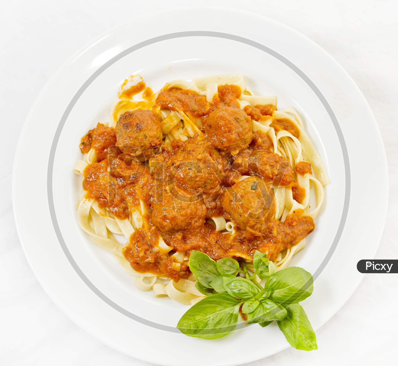 A Plate Of Fettuccine And Meatballs Pasta With Tomato Sauce.