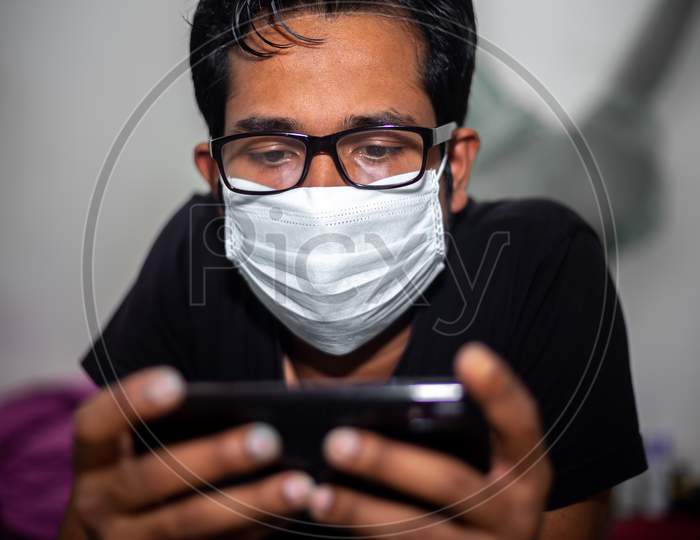 Bangladesh – April 14, 2020: Portrait Of A Young Man Playing Mobile Video Games At Night Deu To Coronavirus Epidemic.