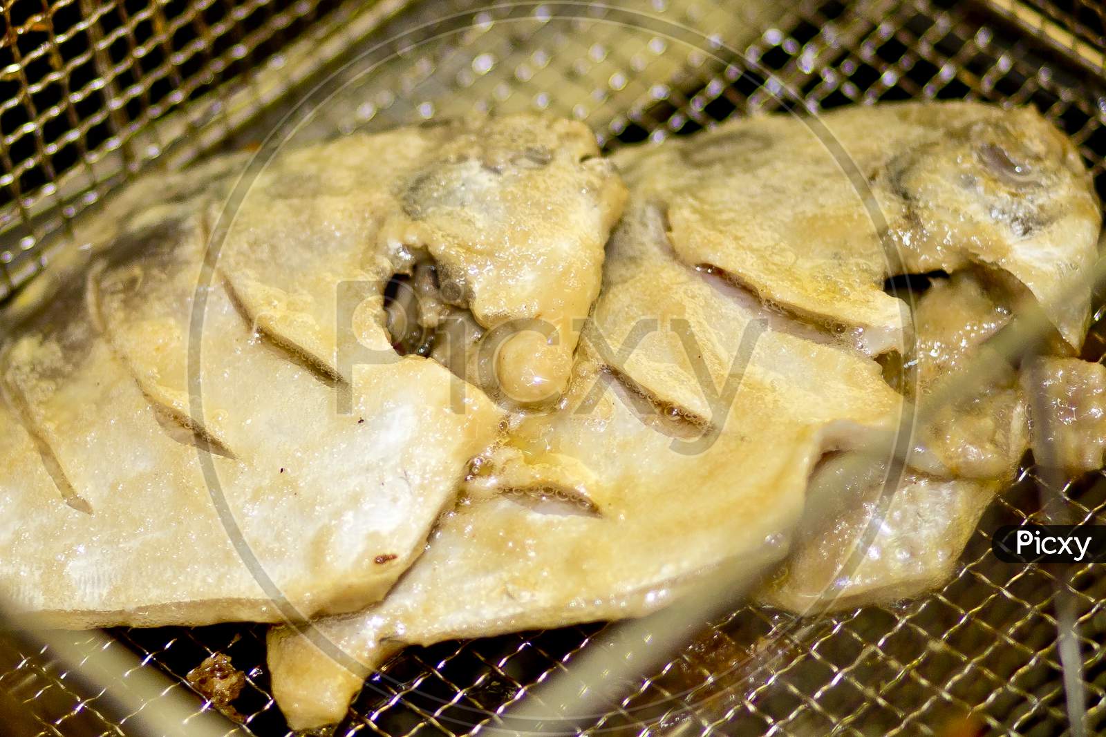 Deep Submerged Oil Fried Pomfret Fish On Hot And Crunchy.