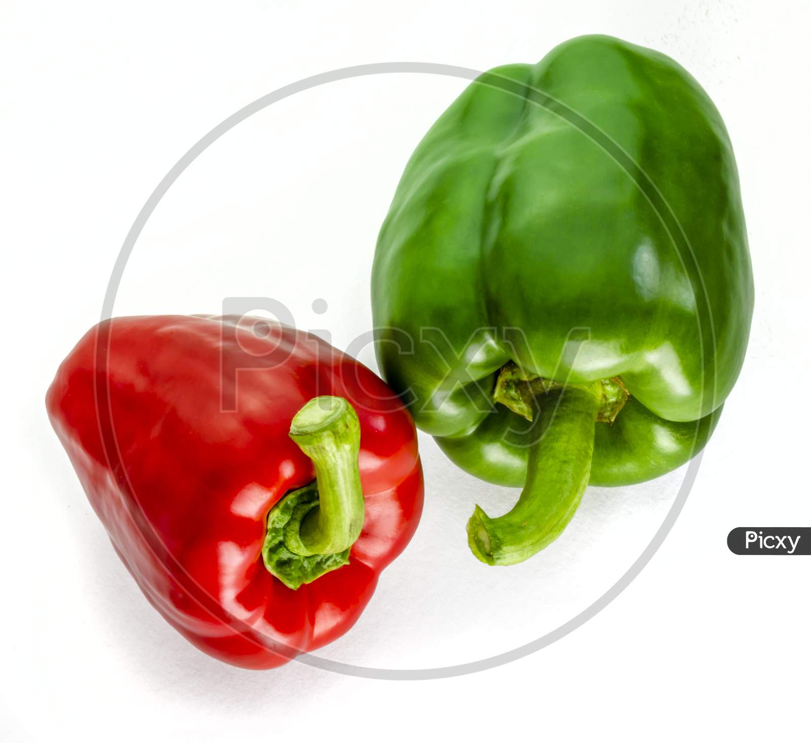 Two fresh peppers on a white background