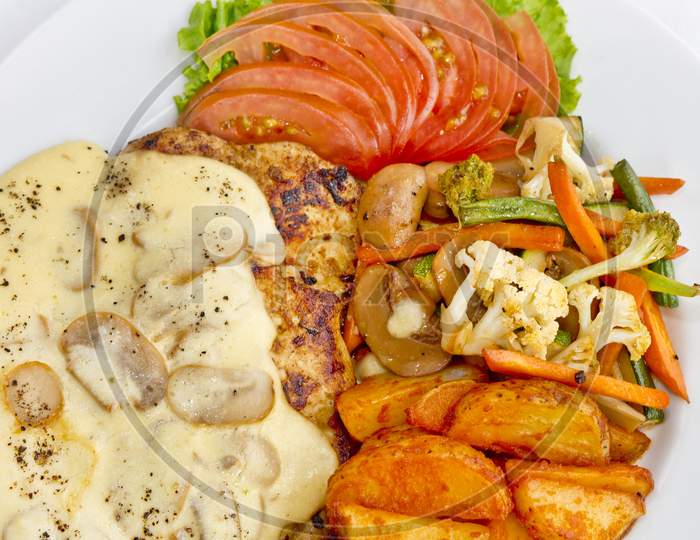 Peri Peri Chicken With Button Mushroom Gravy, Saute Vegetables, Spicy Fried Potatoes With Tomato Lettuce Salad.