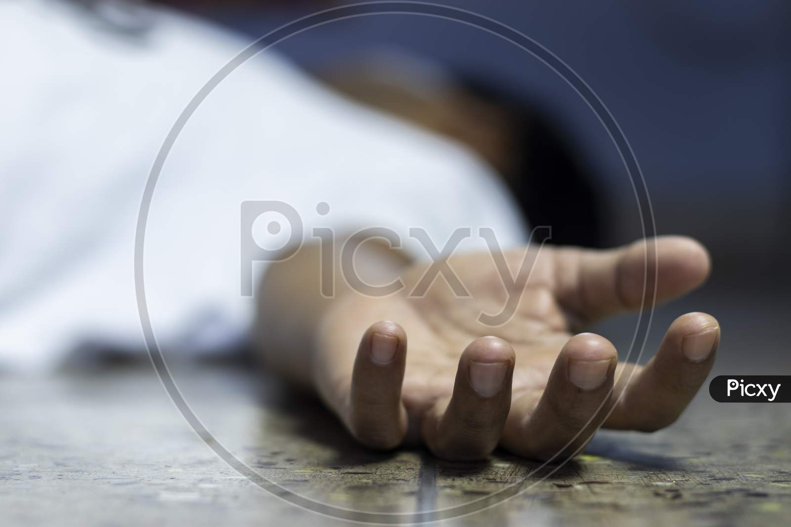 An Indian Or Asian Person Laying On Floor Dead During Covid-19 Or Corona Virus Outbreak With Selective Focus Or Shallow Depth Of Field