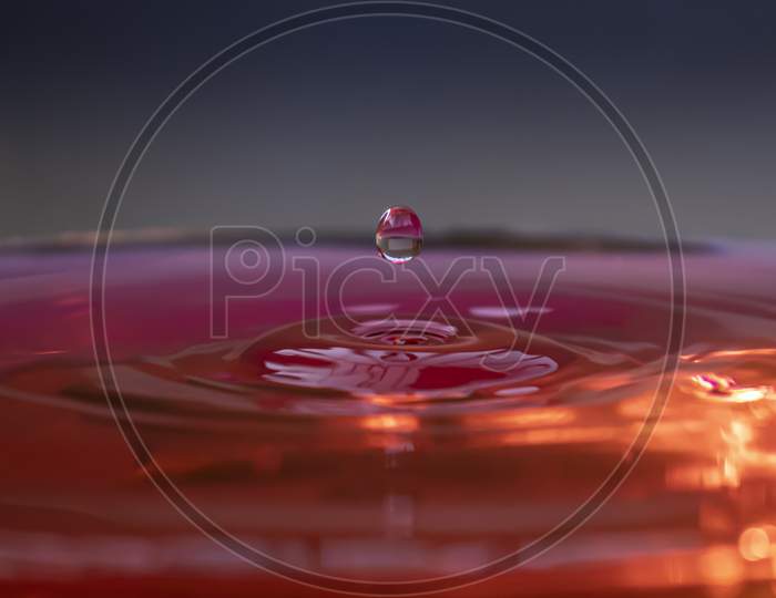 Water Droplet Falling On Water Surface Pink Red Colour