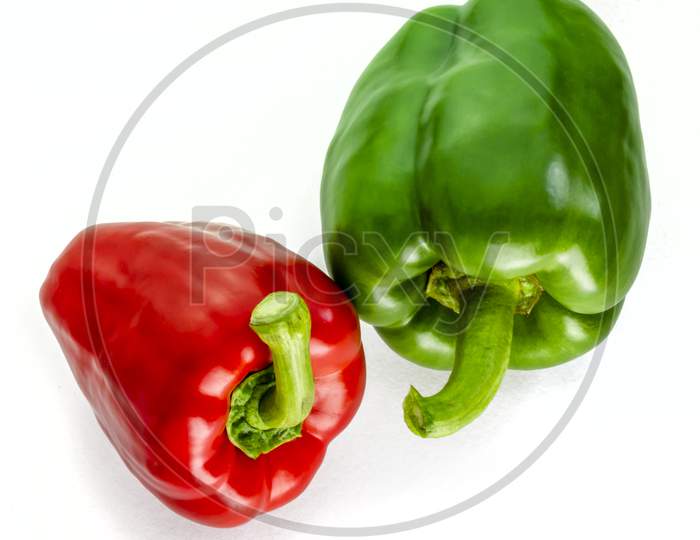 Two fresh peppers on a white background