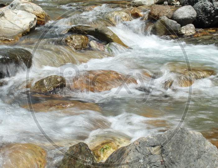 River Water Flowing On Stone Banks