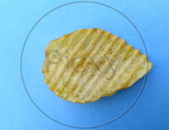 a yellow potato chips eatable food isolated on sky blue background