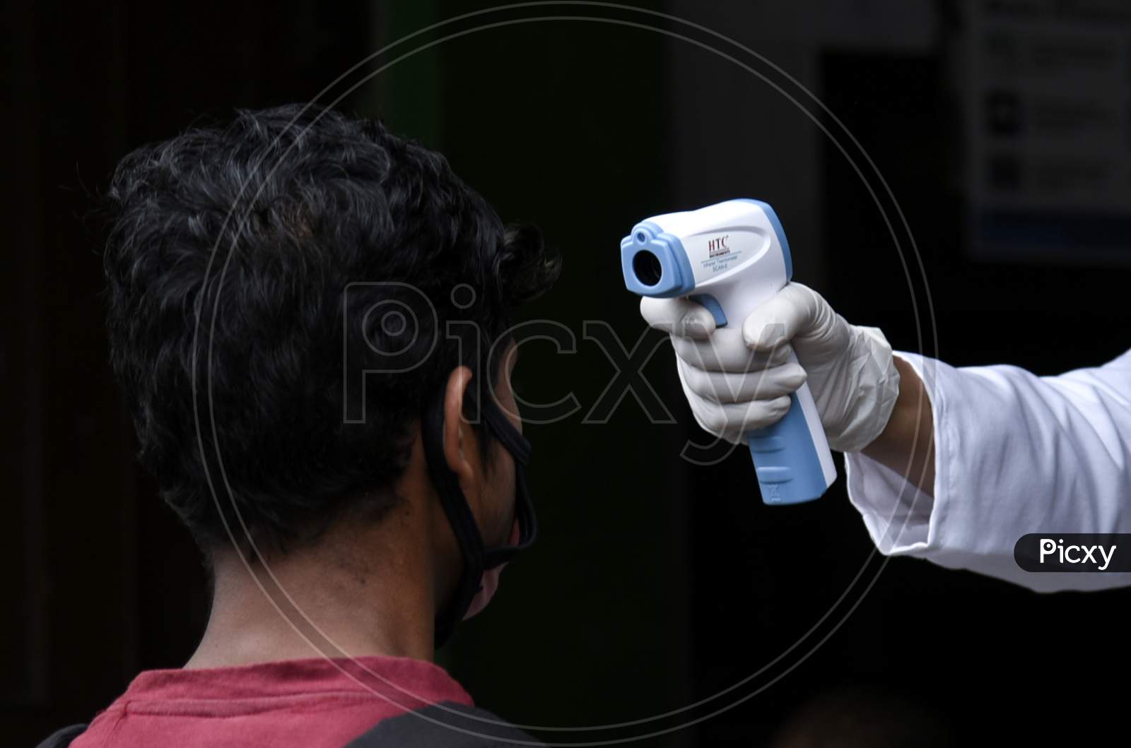 Thermal Scanning Of a Person With Thermometer Gun During Coronavirus Or COVID-19 Pandemic in Guwahati