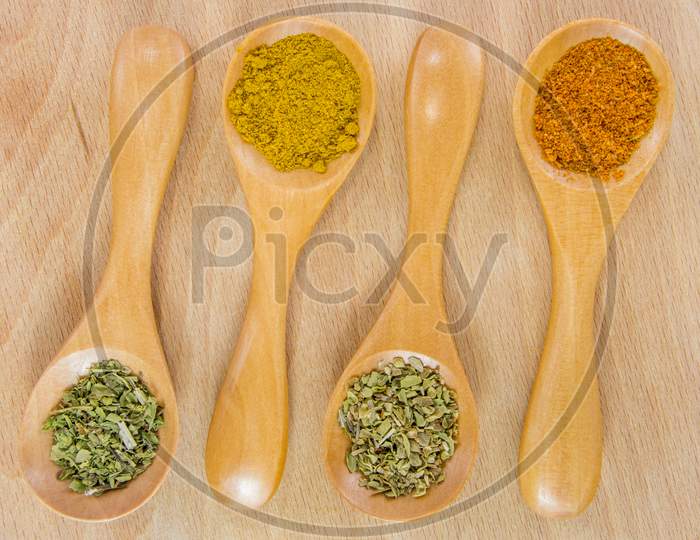 wooden tea spoons with various spices
