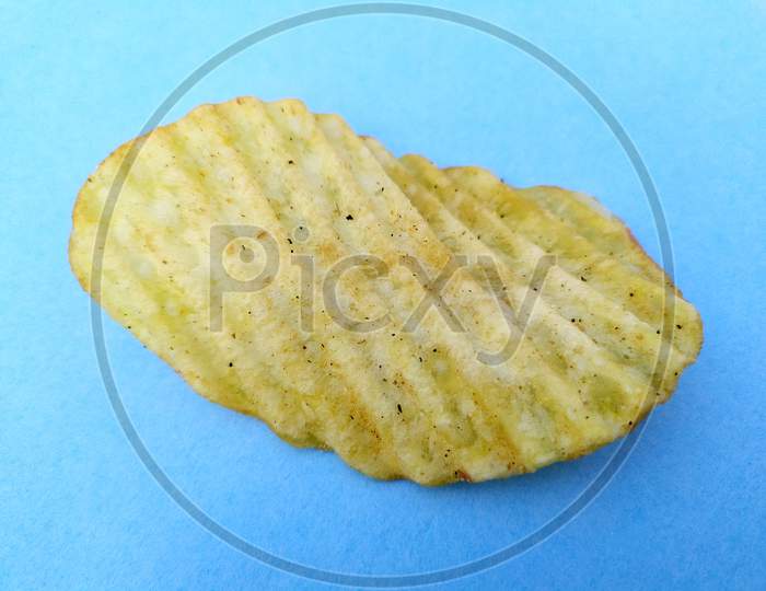a yellow potato chips eatable food isolated on sky blue background