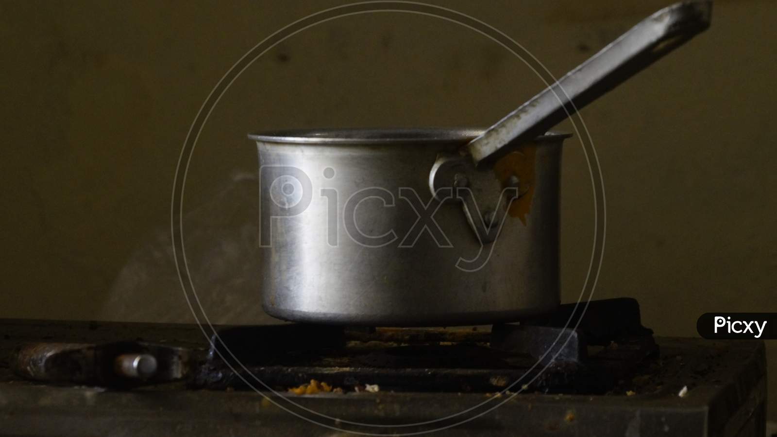Aluminum utensil ready to make tea on gas stove