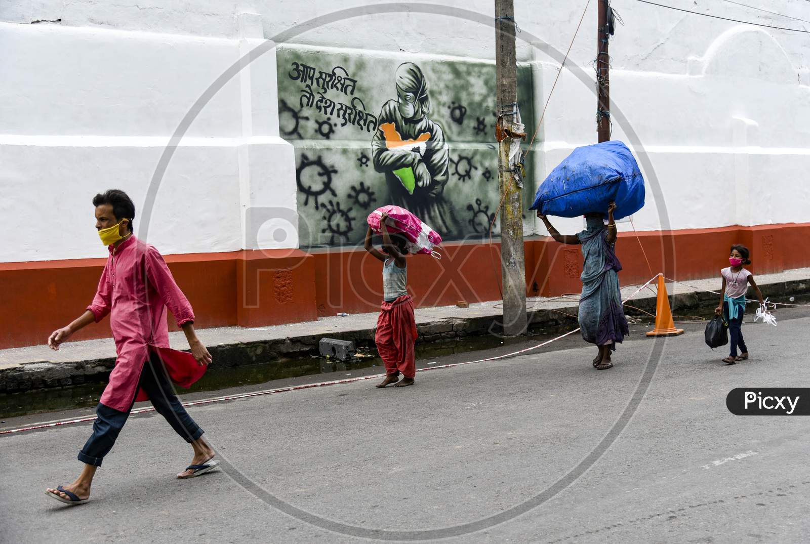 People Walking Past To A Mural Related To Coronavirus, Authorities Eased Restrictions, During The Ongoing Covid-19 Nationwide Lockdown, In Guwahati, On Wednesday, 06 May 2020.