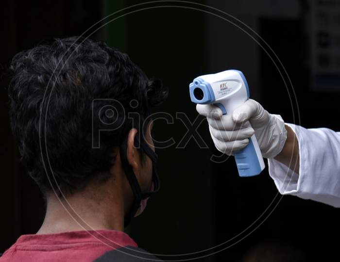 Thermal Scanning Of a Person With Thermometer Gun During Coronavirus Or COVID-19 Pandemic in Guwahati