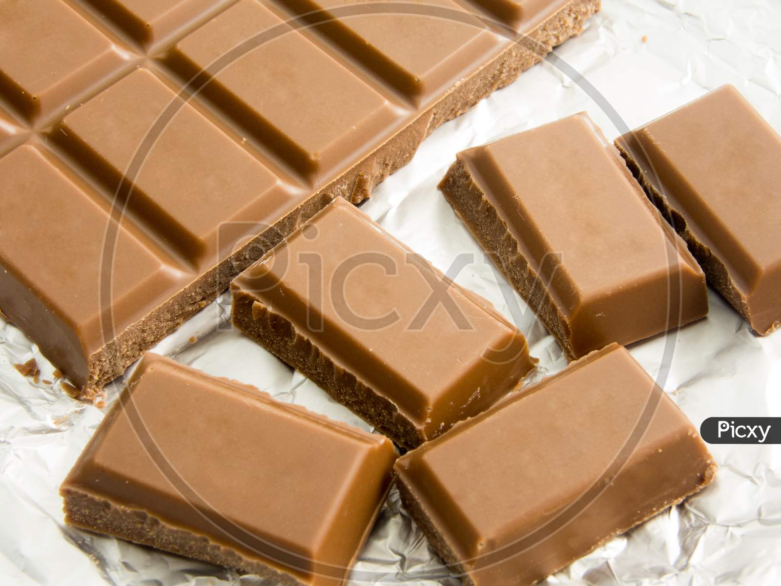 bites of delicious chocolate bar on foil packaging