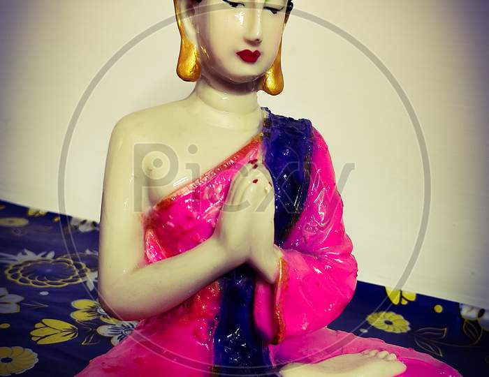 Buddha idol in namaste pose