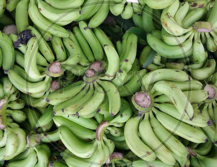 Green bananas in a market