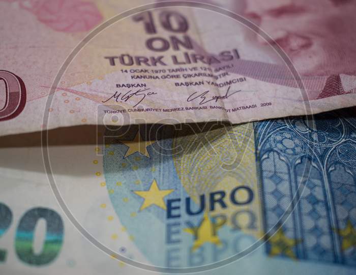 Turkish Lira and euro banknotes close up image.