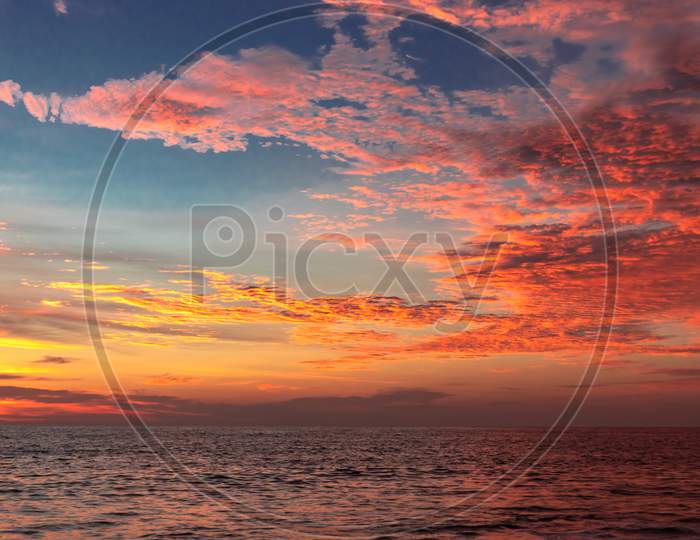 Sunset Orange clouds above sea water