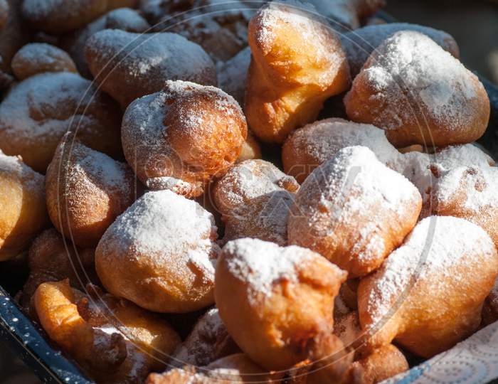 romanian traditional tasty delicious mini doughnuts with powdered sugar above ready for eat