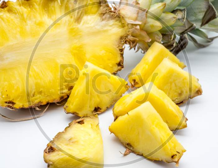 half sliced pineapple on white