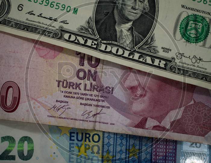 One US Dollar bill, Turkish Lira and euro banknotes close up image.