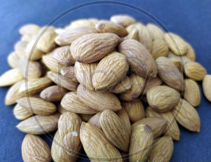 some fresh healthy almonds put on black background