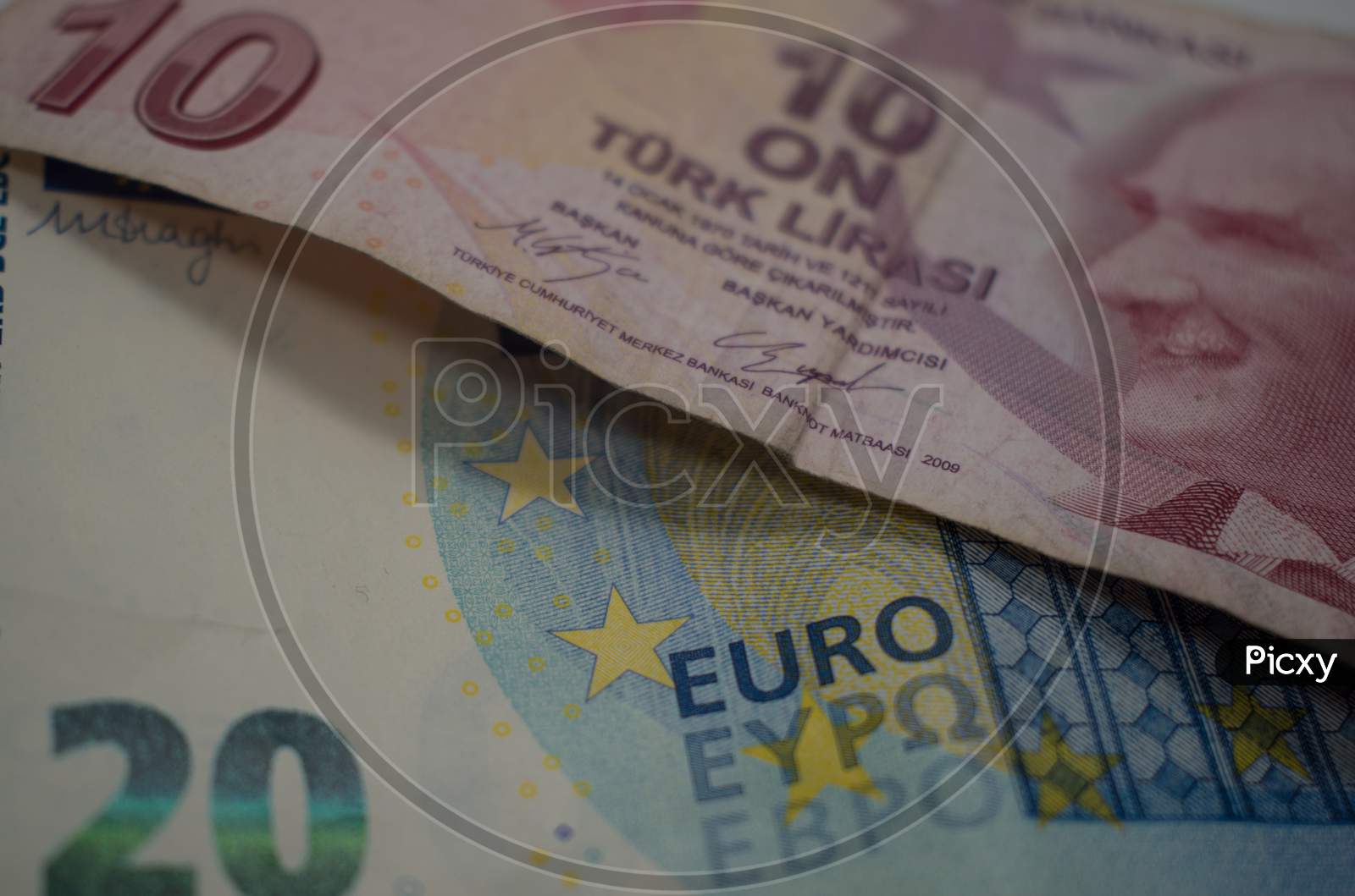 Turkish Lira and euro banknotes close up image.