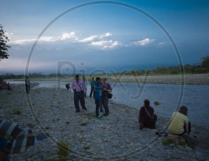 local people and tourists are enjoying themselves on the bank of river Murti in a summer afternoon. indian lifestyle.