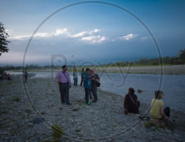 local people and tourists are enjoying themselves on the bank of river Murti in a summer afternoon. indian lifestyle.