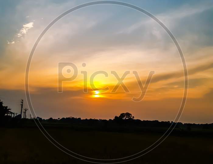 Sunset Time Indian Village Agriculture Land And Sun Light And Yellow-White Color Cloud ,Beautiful Environment.