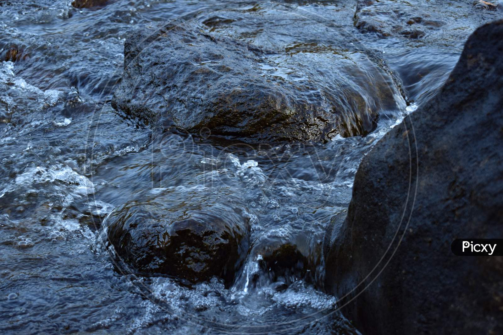 Water flowing in waterfall through rocks