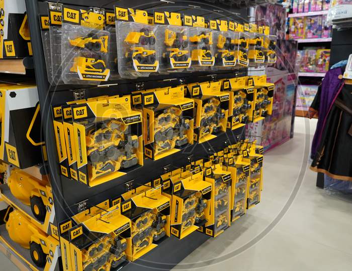 Dubai Uae December 2019 - A Collection Of Cat Excavator And Truck Toys At Toys Store. Toys Hanging In Store For Sale. Cat Brand Toys In A Toy Store.