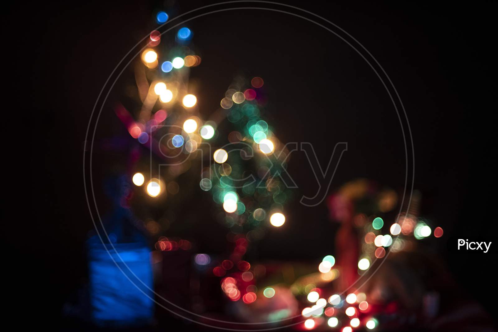 Blurred image of a decoration with Christmas trees, lights, gifts,toys, Santa Clause, candles for the celebration of Christmas and new year. Indian lifestyle and Christmas celebration.