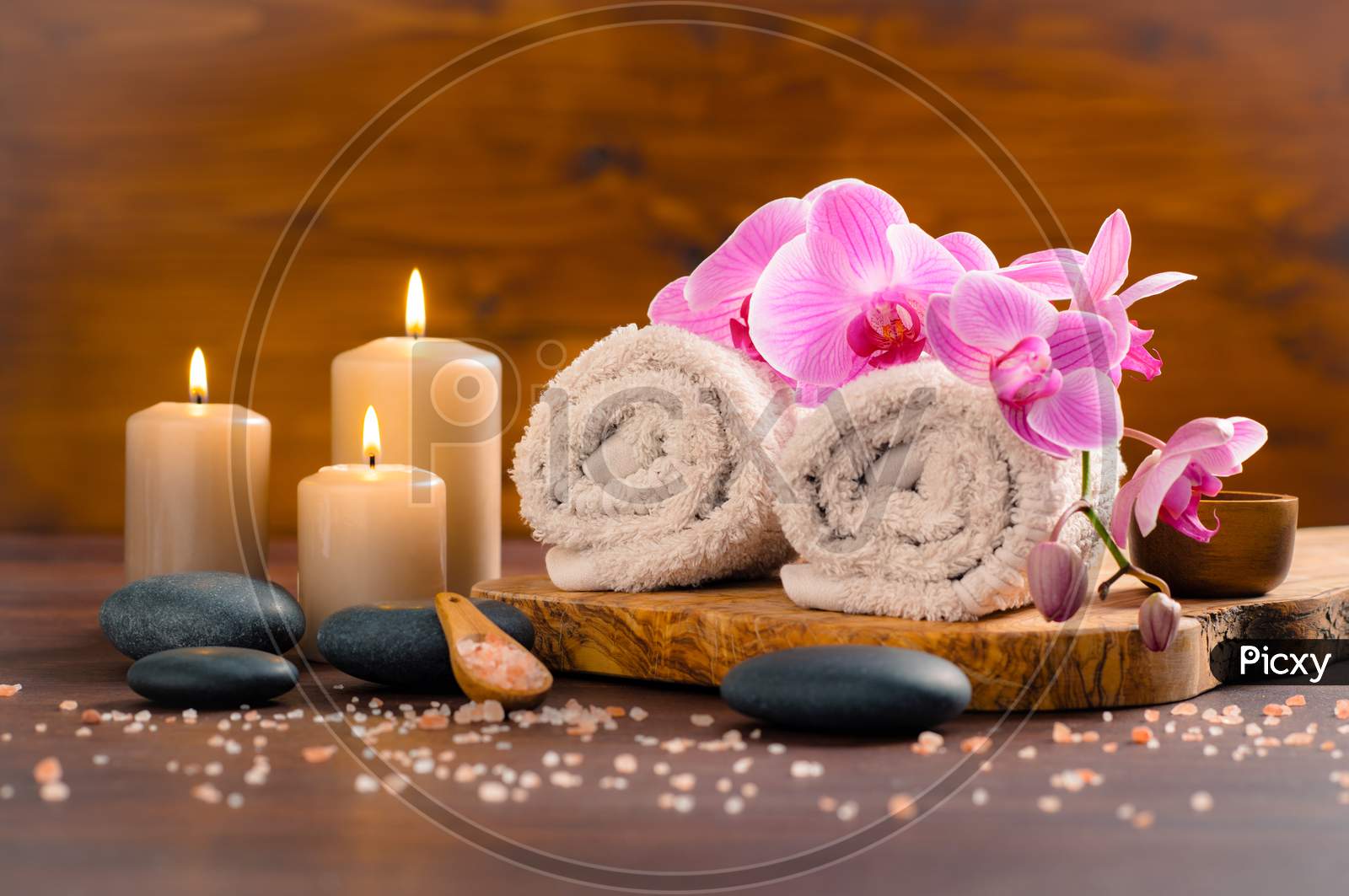 Black stone with candles for spa wooden background