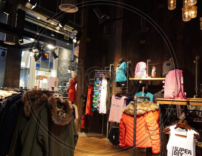 Dubai Uae December 2019 Clothes Displayed For Sale Inside Clothing Store. Interior View Of Super Dry Clothing Brand Retail Store. Inside View. Jackets, Coats Shirts Etc.