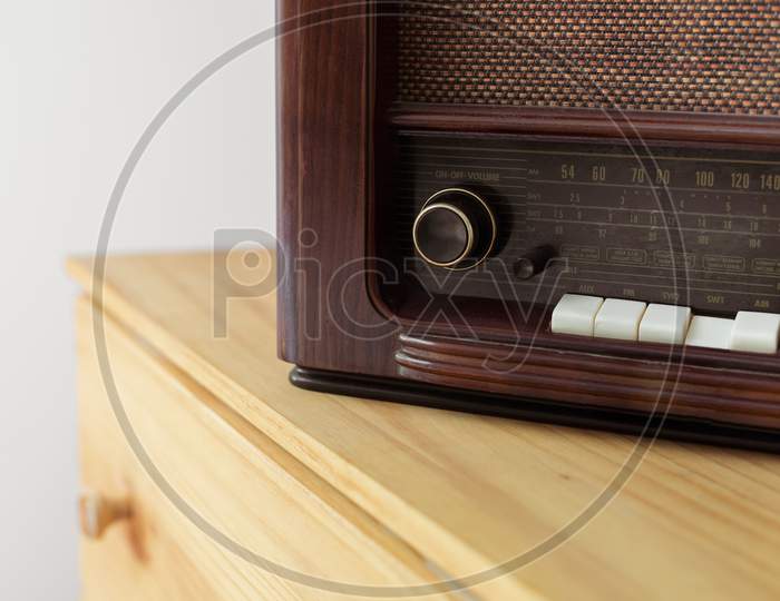 Vintage radio made of wood and green vase on a old table