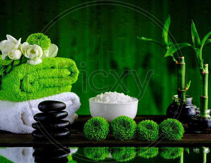 Green and white wall with black stone green background for spa