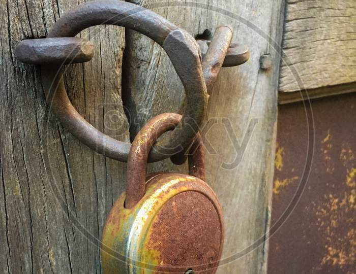India - May 8, 2020: old lock on a wooden gate, with raw background