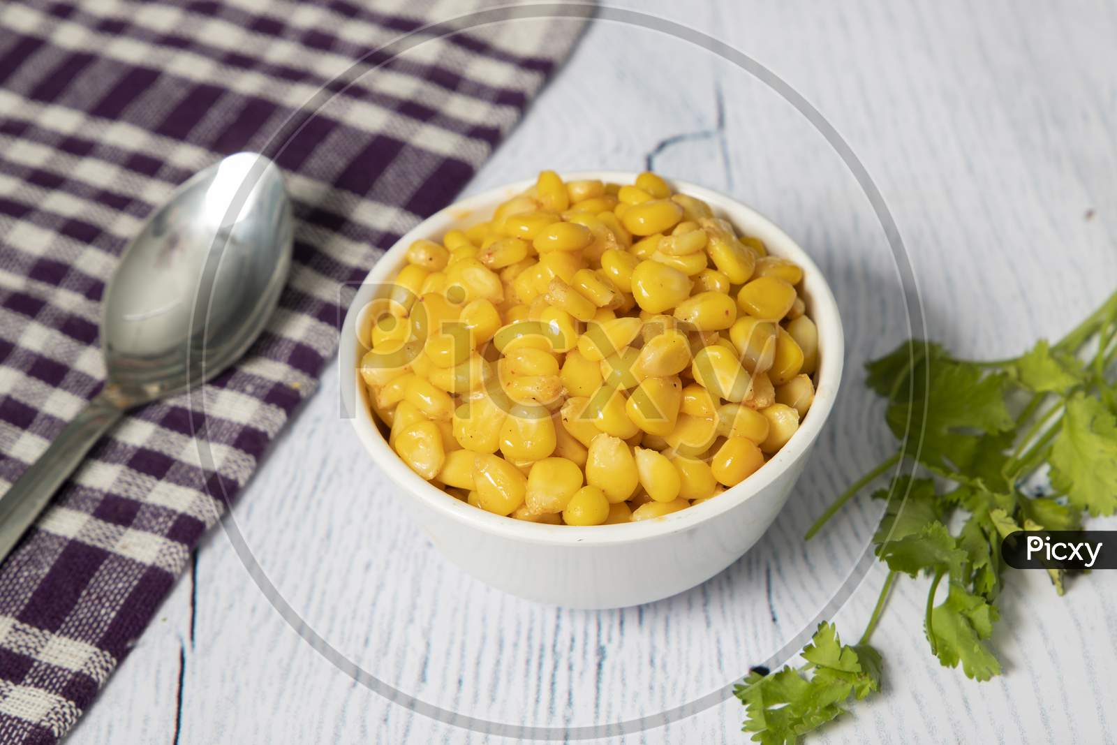A cup of cooked sweet corn.