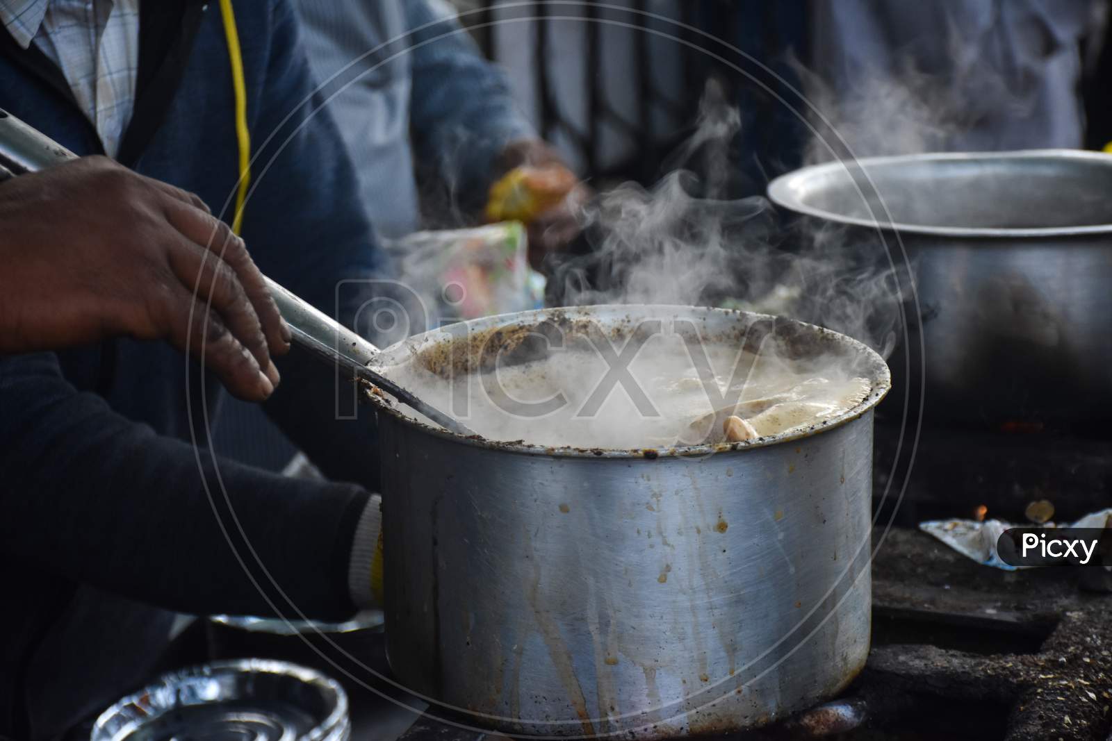 Nainital/India - May 7, 2020: man making tea, on a street in nainital mall road