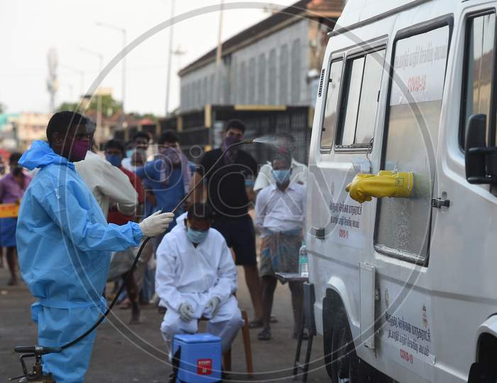 Medics Wearing Protective Suits Sanitise Their Hands After they Collect Swab Samples For Labourers Of Koyambedu Vegetable Market During A Government-Imposed Nationwide Lockdown As A Preventive Measure Against The Spread Of Covid-19 Or Coronavirus, In Chennai
