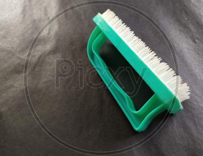 Hand brush to clean dirty clothes,Black background.