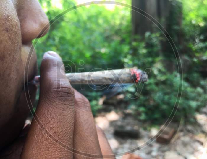 Kashol/India - May 09, 2020: boy smoking a weed joint in himachal kashol in india, Kashol Tourism