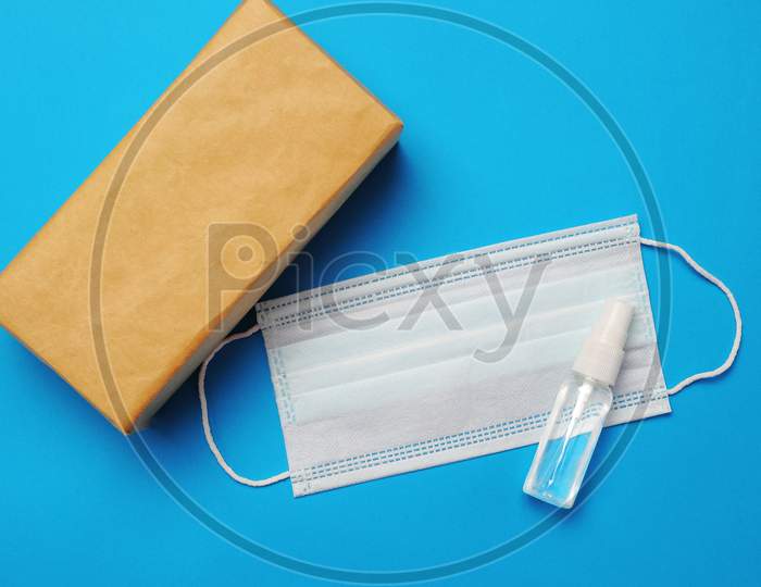 Brown Closed Carton Delivery Packaging Box ,Hand Sanitizer Spray And Surgical Facial Mask As Protection Against Influenza